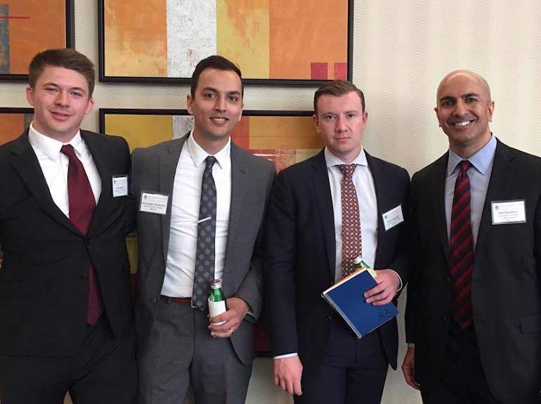 Members of the Economics Club pose for a photo with Neel Kashkari, CEO and President of the Federal Reserve Bank of Minneapolis.
