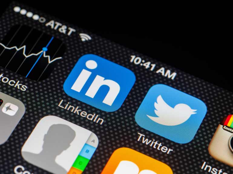 iPhone screen featuring apps for LinkedIn, Twitter and Instagram.